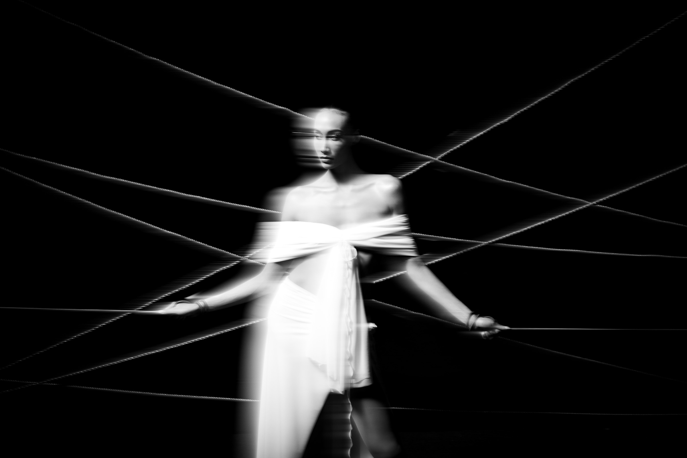 A blurred portrait from Duality, with a woman in white surrounded by intersecting ropes